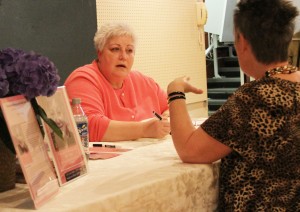 Cynthia Eggl chats with a reader at a recent book signing.